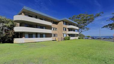 Right on the sands at Little Beach and walk to the heart of Nelson Bay