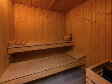 Rustic holiday home with sauna and jacuzzi in wooded area