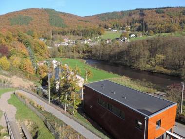 Lovely modern cottage with sauna bubble baths and even a beach on the river!