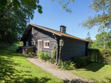 Open wooden chalet built against a hill.