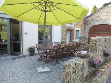 Very well kept house with a fireplace situated near a forest