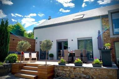 Very well kept house with a fireplace situated near a forest