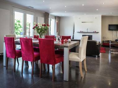 Very well kept house with a fireplace situated near a forest