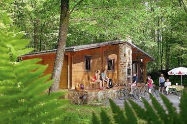 Cozy wooden chalet with a microwave located in a forest