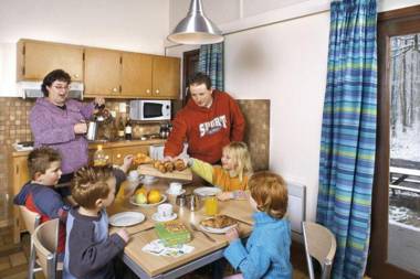 Cozy wooden chalet with a microwave located in a forest