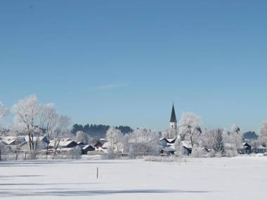 Holiday home in the Allgäu featuring a tiled stove and a private terrace with mountain views.
