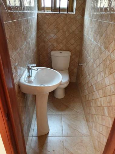 EXECUTIVE APARTMENT 2 master ensuite bedrooms 3 toilets 3 baths hot water air conditioned separate fitted kitchen separate living room large compound 24hr security electric fenced wall restaurant bar WIFI about 20 minutes from the airport