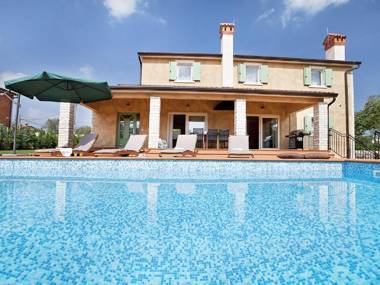 Beautiful villa with swimming pool surrounded by a natural fence