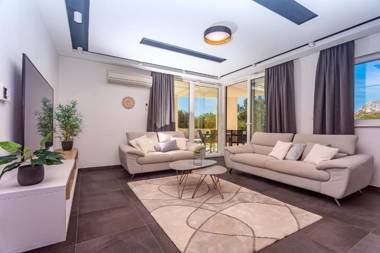 VILLA CVITA is a modern 5-bedroom villa with a Jacuzzi a Gym and Finnish Sauna a heated pool and amazing views