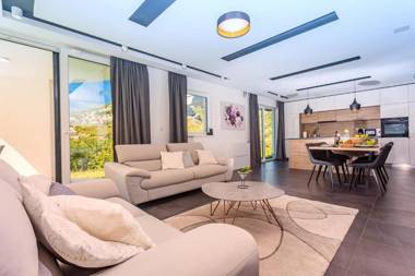 VILLA CVITA is a modern 5-bedroom villa with a Jacuzzi a Gym and Finnish Sauna a heated pool and amazing views