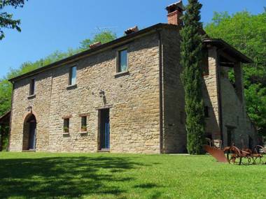 Stone house in the green rolling hills of the Apennines with garden.
