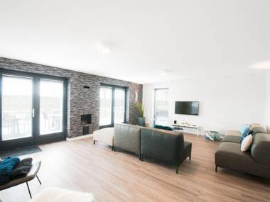 Modern wellness lodge with sunshower in a national park.
