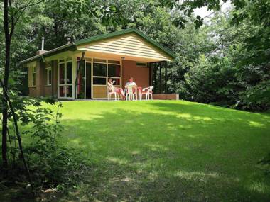 Nicely furnished bungalow with a fireplace and green area