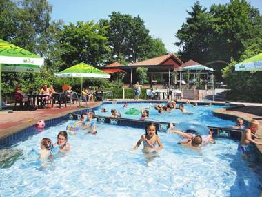 Nicely furnished bungalow with a fireplace and green area