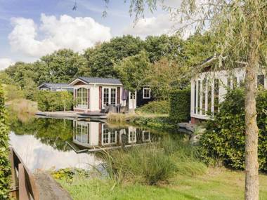 Comfy chalet with a dishwasher directly on a pond