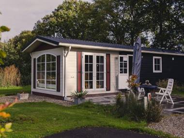 Comfy chalet with a dishwasher directly on a pond
