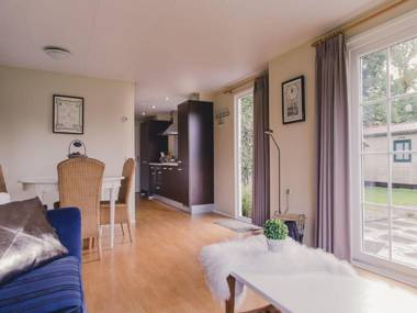 Comfy chalet with a dishwasher directly on a pond