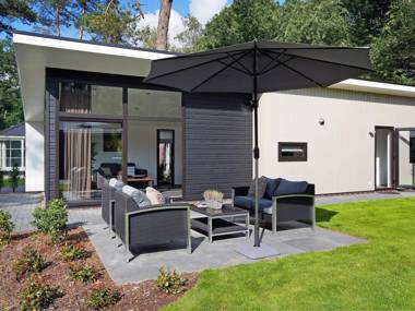 Modern designed chalet with a smart TV next to the forest