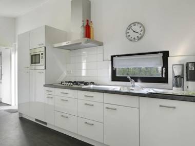 Modern designed chalet with a smart TV next to the forest