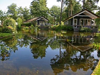 Atmospheric house on the water surrounded by nature
