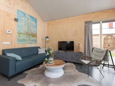 Modern bungalow with an outdoor fireplace by the water