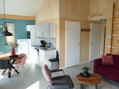 Modern bungalow with an outdoor fireplace by the water