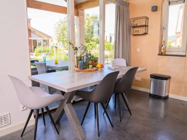 Modern bungalow with an outdoor fireplace by the water