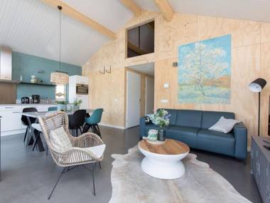 Modern bungalow with a fireplace located directly by water