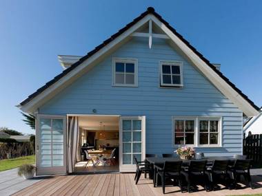 Spacious modern holiday home with a fireplace near the sea