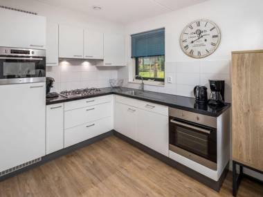 Luxurious villa with sun shower in a wooded area