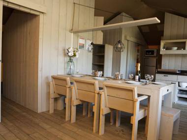 Striking tent lodge with a porch located near the Veluwe