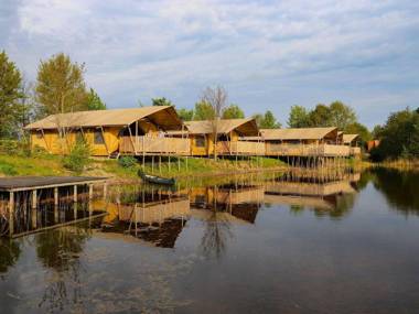 Lovely tent with a kitchen and bathroom located near a pond
