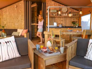 Lovely tent with a kitchen and bathroom located near a pond