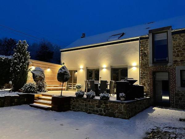 Very well kept house with a fireplace situated near a forest