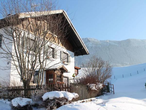 Holiday home in the Allgäu featuring a tiled stove and a private terrace with mountain views.
