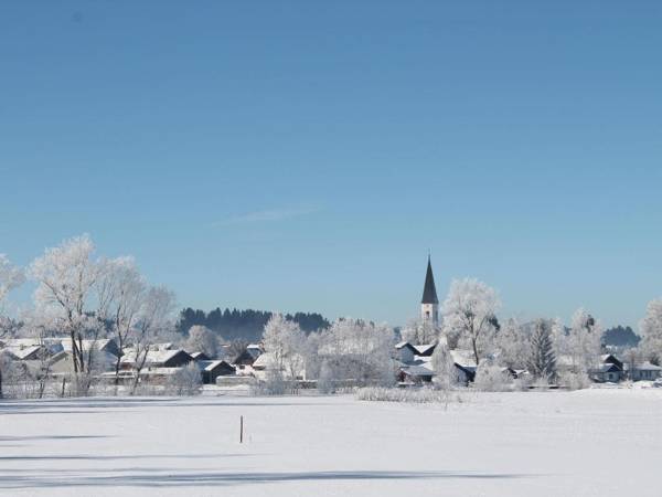 Holiday home in the Allgäu featuring a tiled stove and a private terrace with mountain views.