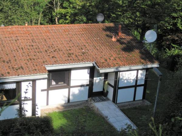 Detached wooden bungalow in a green wooded area