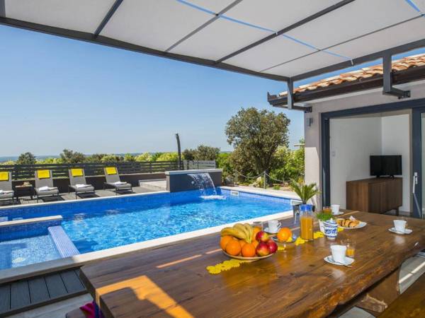 Villa with swimming pool outdoor kitchen sauna jacuzzi play area and sea view