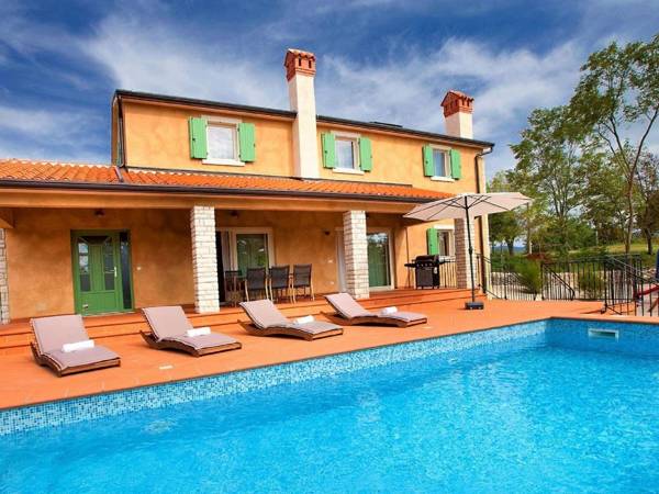 Beautiful villa with swimming pool surrounded by a natural fence