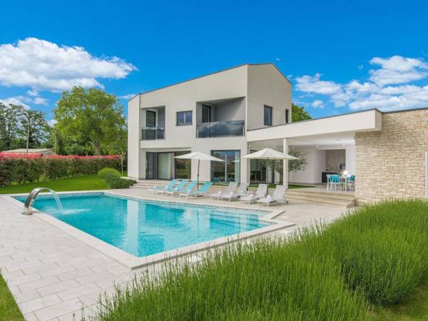 A modern luxury villa with a crystal-clear swimming pool and cultivated garden