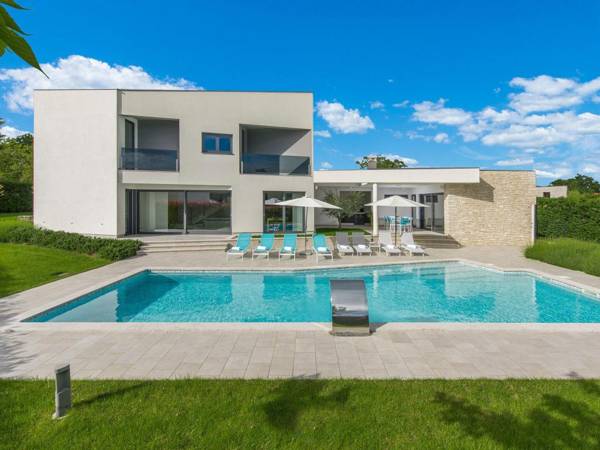 A modern luxury villa with a crystal-clear swimming pool and cultivated garden
