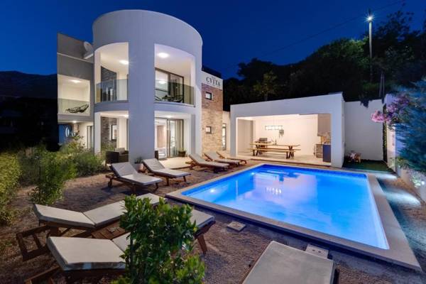 VILLA CVITA is a modern 5-bedroom villa with a Jacuzzi a Gym and Finnish Sauna a heated pool and amazing views