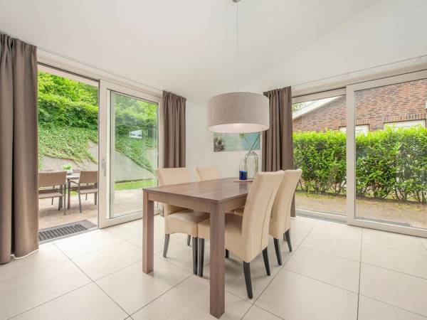 Modern bungalow with washing machine in green surroundings