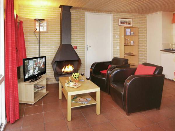 Nicely furnished bungalow with a fireplace and green area