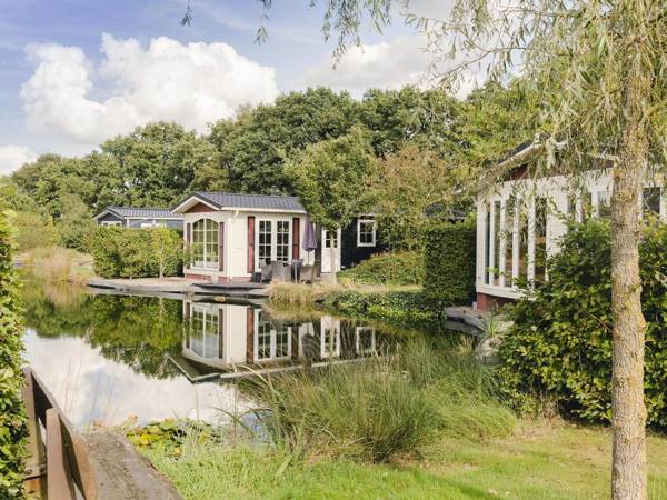 Comfy chalet with a dishwasher directly on a pond
