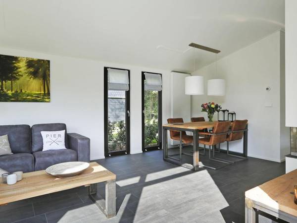 Modern designed chalet with a smart TV next to the forest