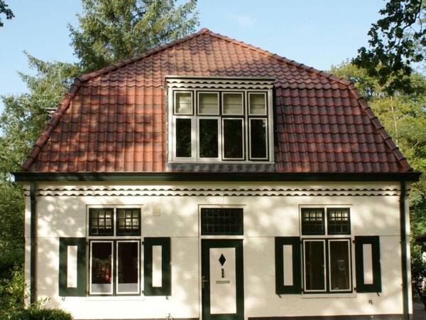 Characteristic house with a garden surrounded by forest