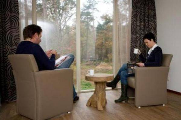 Modern villa with decorative fireplace in a holiday park on De Veluwe