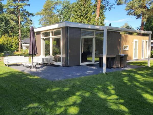 Comfy chalet with sunshower located in a forrest