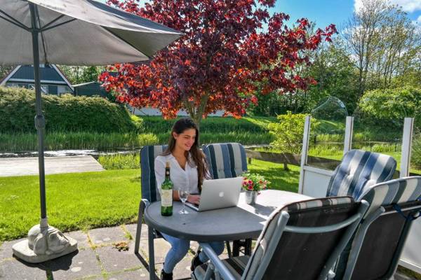 Lilian Modern Holiday home at a typical dutch canal close to the Lauwersmeer
